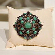 Bronze Brooch with Green Jewels by Olivia Riegel